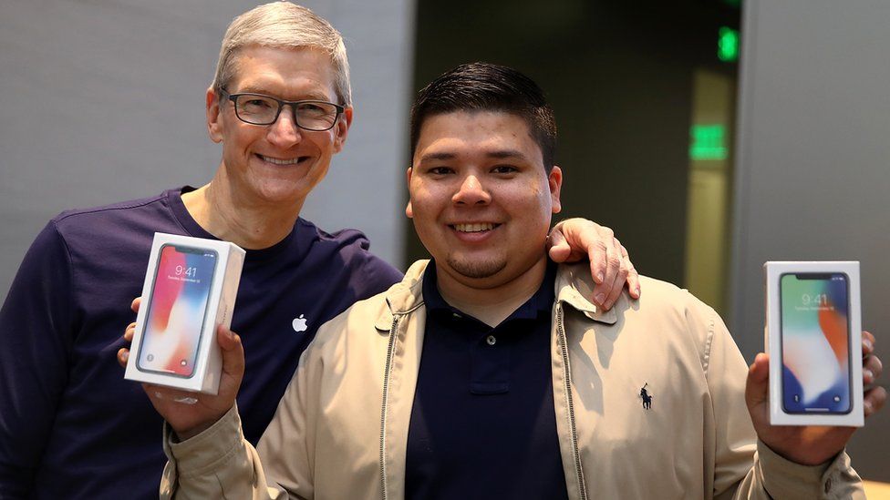 Apple chief executive Tim Cook and iPhone X buyer David Casarez in Palo Alto last November