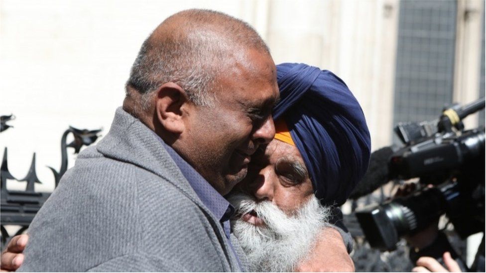 Harjinder Butoy (left) hugs his father outside court
