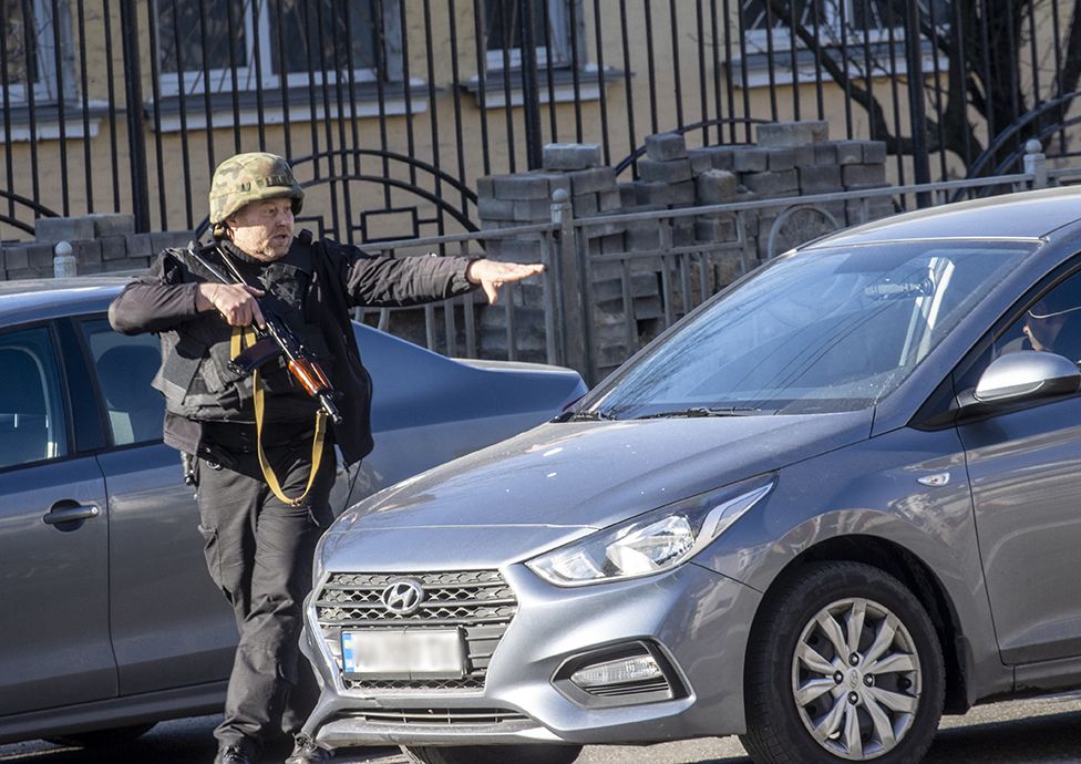 A soldier check vehicles in Zhuliany neighbourhood of Kyiv, on February 26, 2022