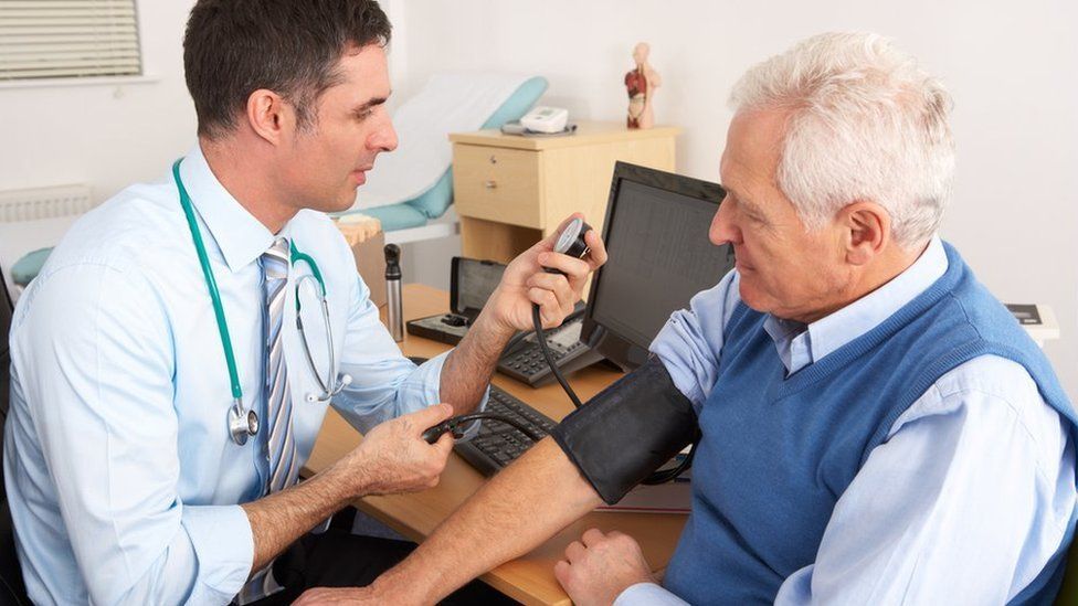 A GP takes a patients blood pressure