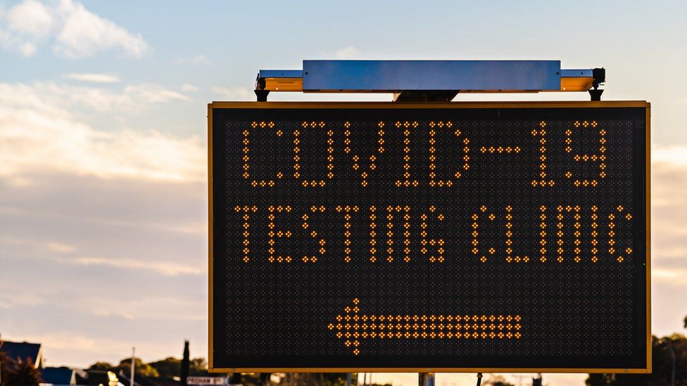 Covid-19 testing clinic sign with arrow
