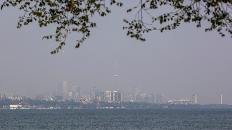 Toronto's skyline is seen with a blanket of smoke from wildfires in Ontario and Quebec,