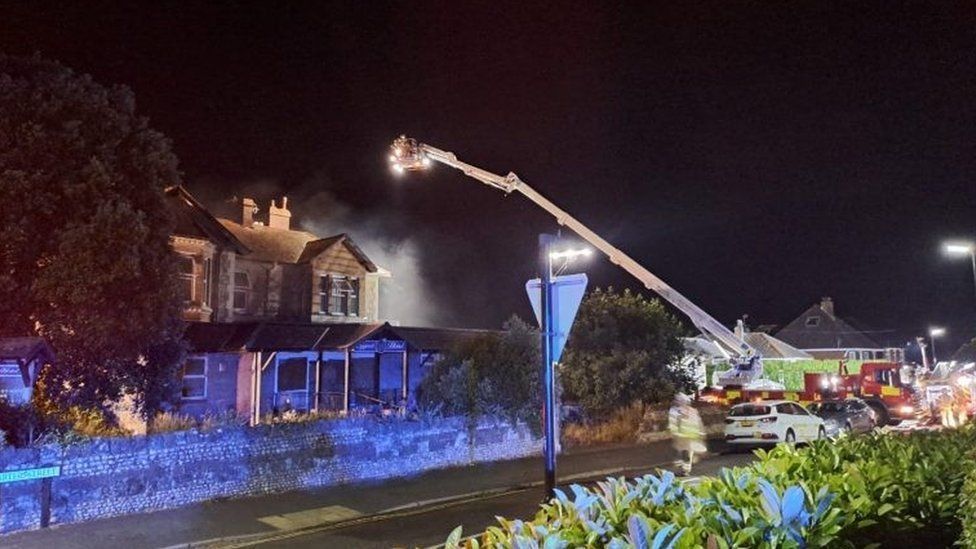 An aerial ladder platform with firefighters putting out the fire at the Cygnet Hotel
