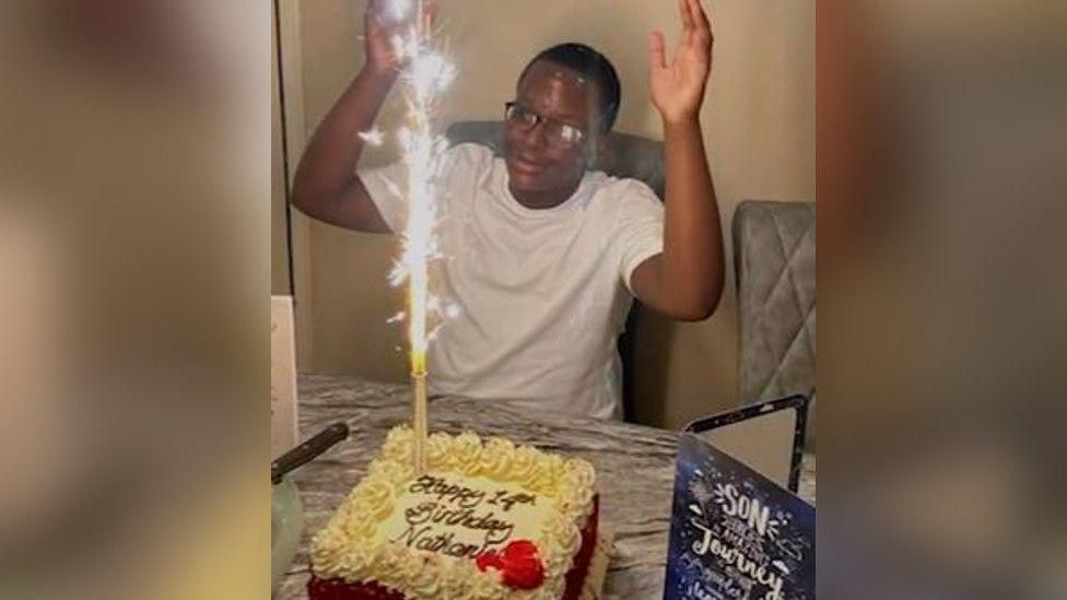 Nathaniel Shani celebrates his 14th birthday with a cake