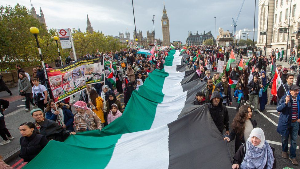 People carry a large Palestinian flag during a protest in London