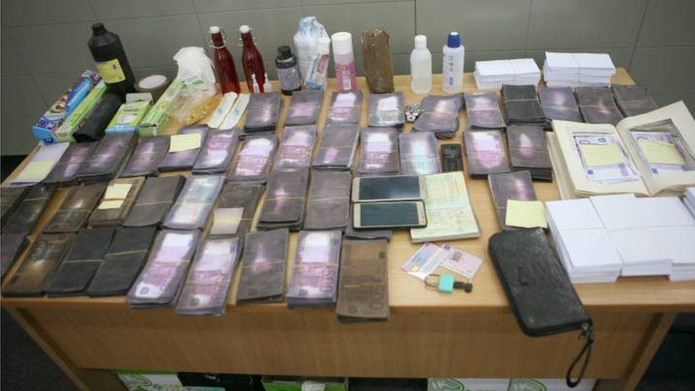The evidence seized by police is arranged on a table at a press event held by the authorities