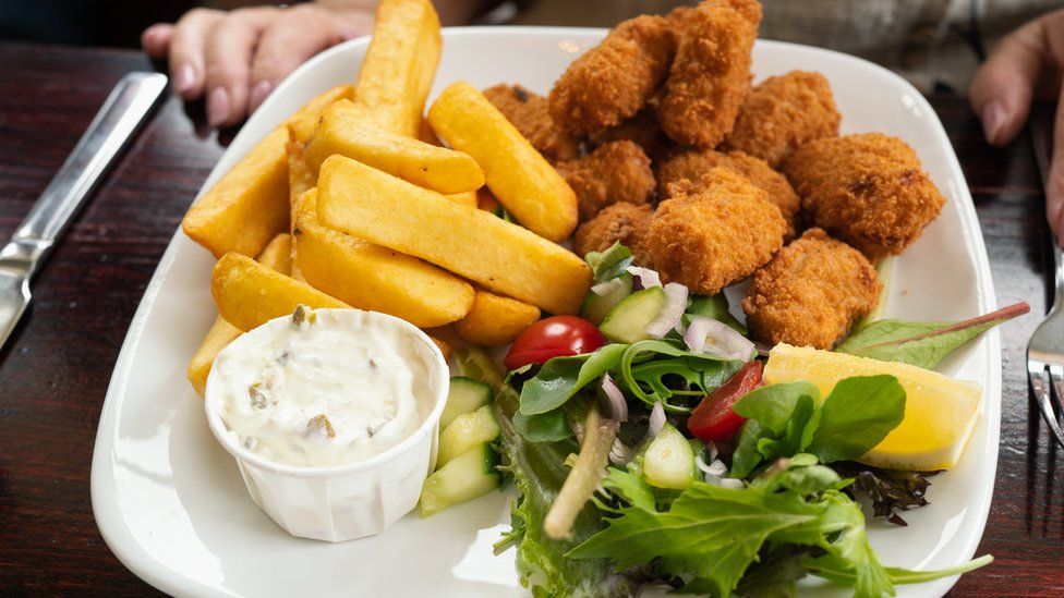 Plate of scampi with chips and salad