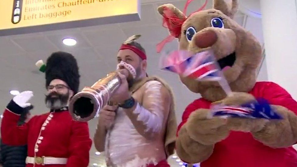 A Queen's Guardsman, didgeridoo player and person dressed as a kangaroo