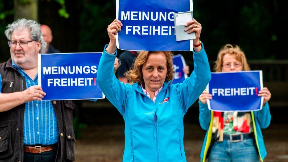 Deputy Leader of the Alternative for Germany (AfD) Beatrix von Storch holds up a placard reading: "Freedom of Speech" during a protest against lockdown measures due to the new coronavirus COVID-19 pandemic, in Berlin on May 23, 2020