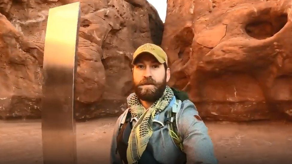 David Surber standing in front of the monolith