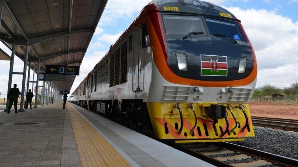 One of Kenya"s newly acquired standard gauge rail locomotive, carrying Kenyan President pulls into Voi railway station on May 31, 2017 in Voi, during an inaugural ride on Kenya"s new standard gauge railway from the coastal city of Mombasa to the capital, Nairobi.