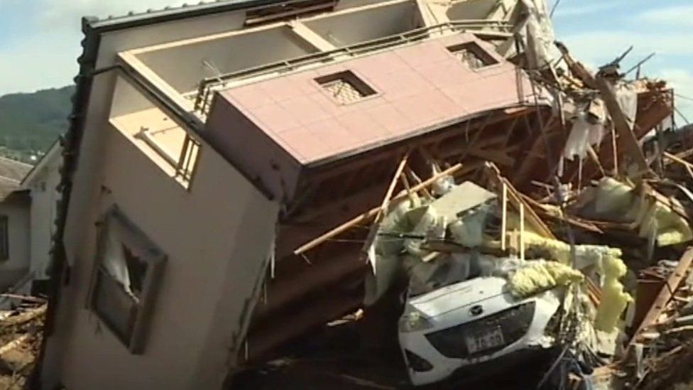 House swept on top of car, Japan
