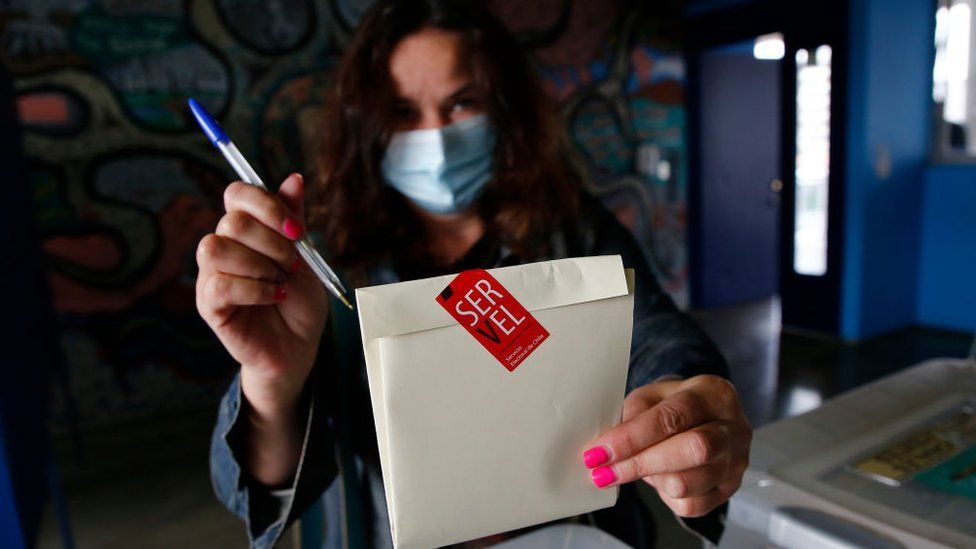 A Chilean woman shows her votes during the Constitutional Convention Election