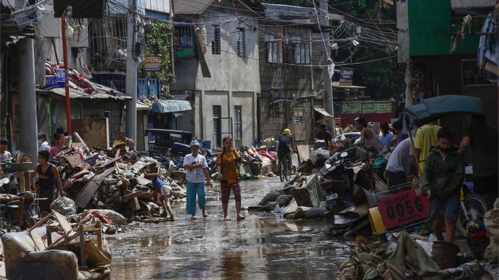Residents return to recover muddied belongings from their homes in Marikina City, Metro Manila