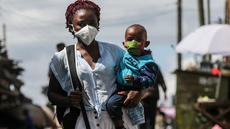 A Kenyan woman together with her son wear face masks during Easter Sunda