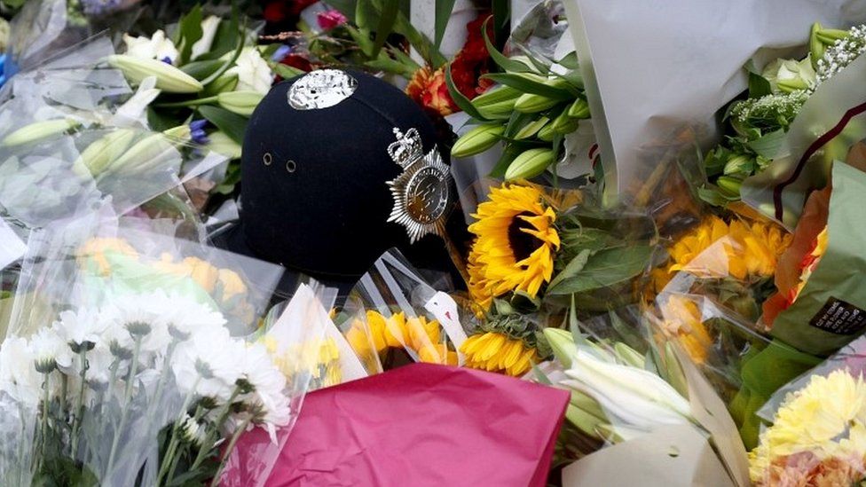 Police helmet among tributes