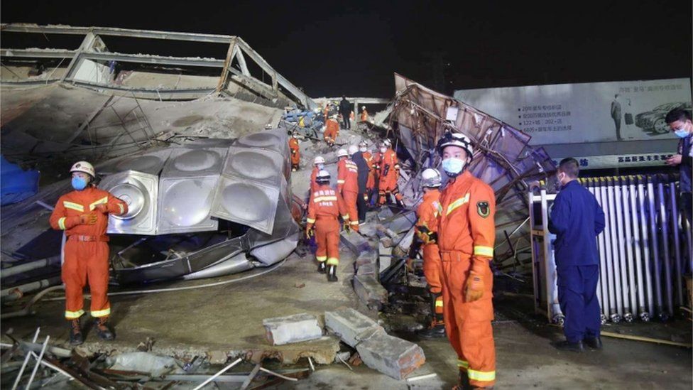 Rescuers work at the site of a collapsed five-story hotel building in Quanzhou city in southeast China's Fujian province, 07 March 2020.