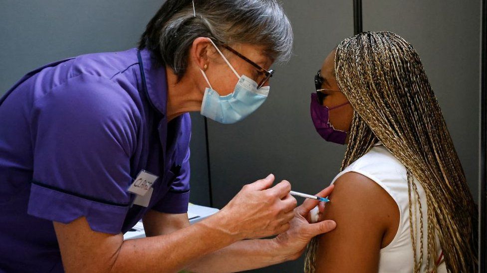 Woman receiving Covid vaccination from medic at Tate Modern on 17 July 2021