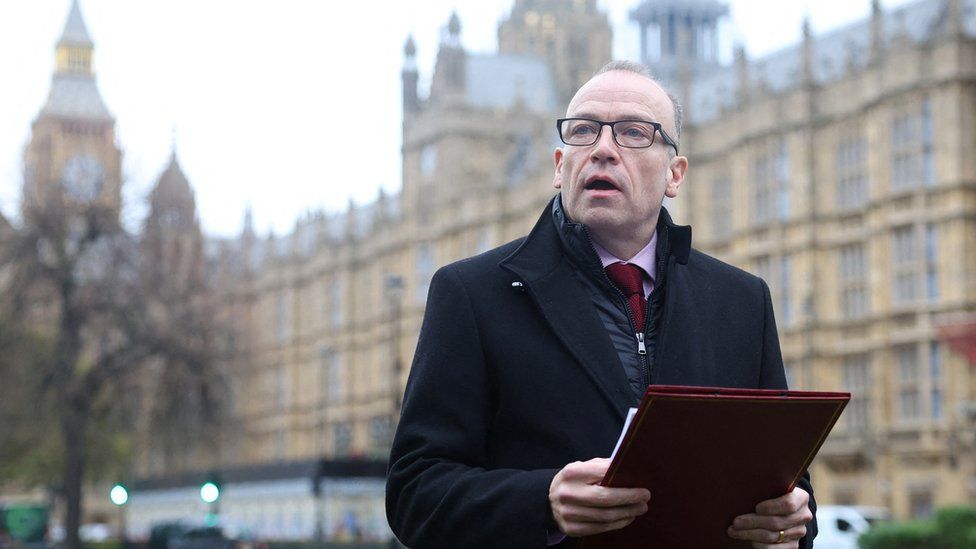 Secretary of State for Northern Ireland Chris Heaton-Harris delivers a statement to media members near the Houses of Parliament is expected to update parliament on the deal