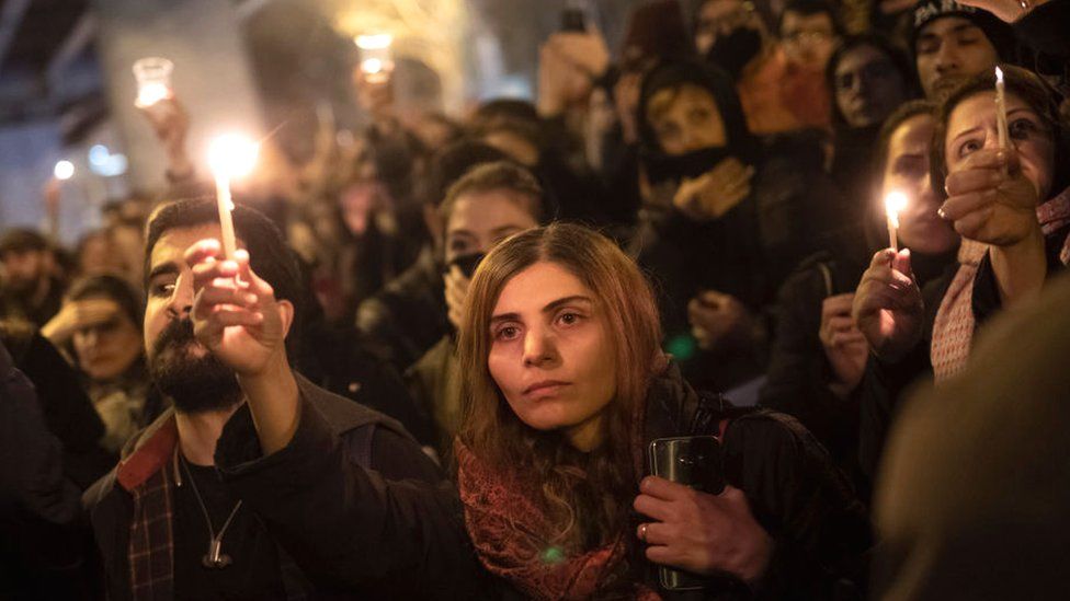 Iranians gather in front of a University and light candles in memory of the victims of the Ukraine Boeing 737 passenger plane