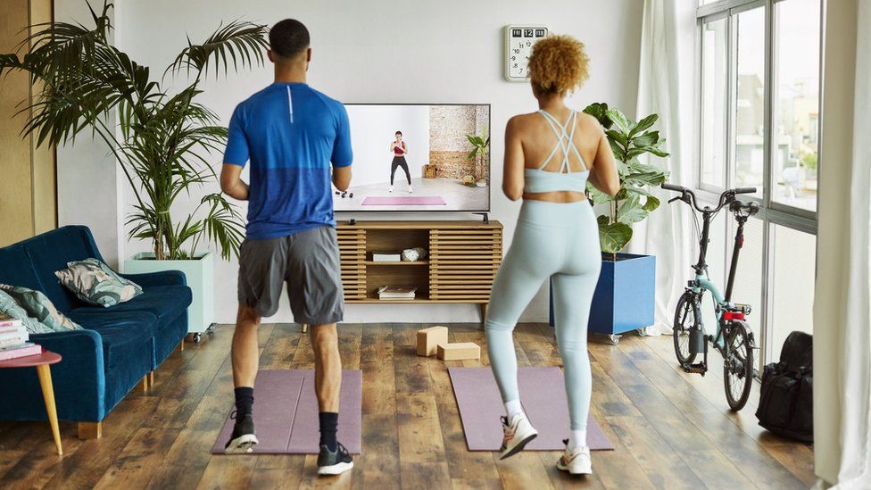 Man and woman working out at home