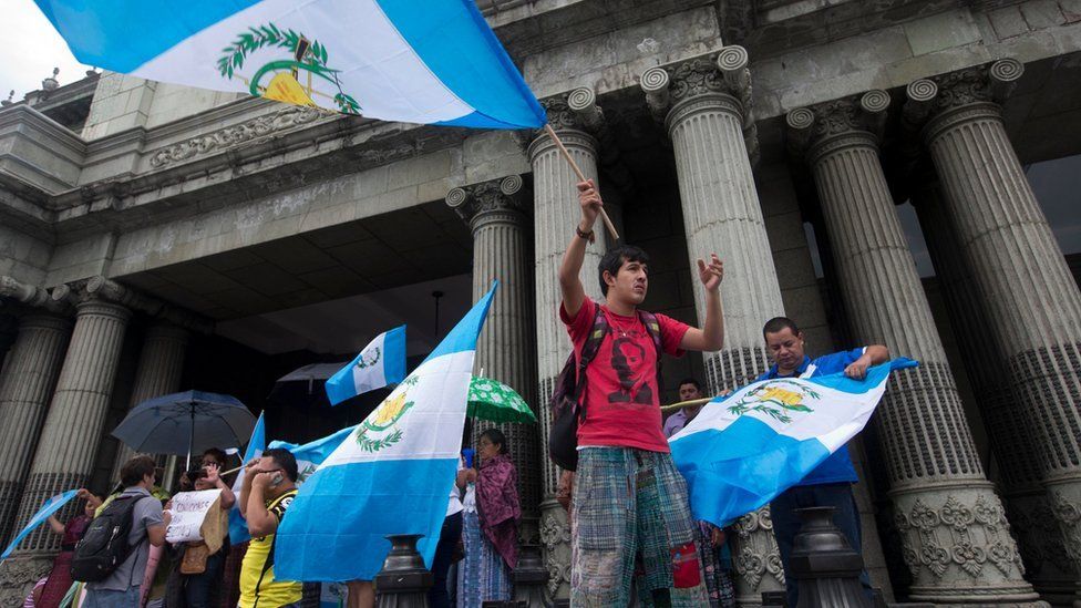 Guatemalans wave national flags as they celebrate the resignation of President Otto Perez Molina, in Guatemala City, Thursday, Sept. 3, 2015