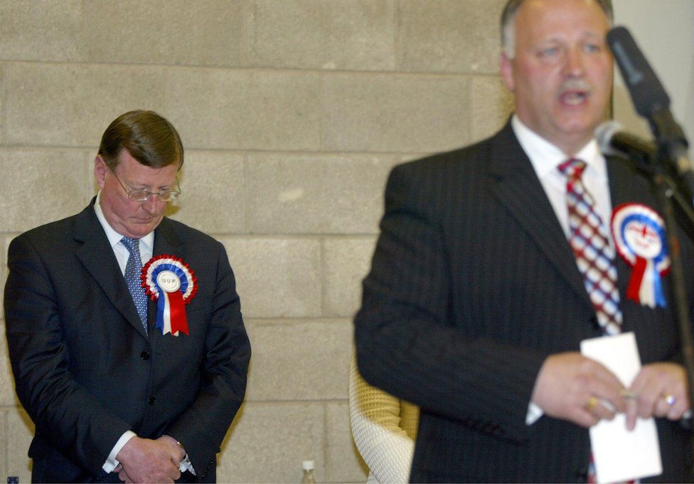 David Trimble bows his head after electoral defeat to the DUP's David Simpson