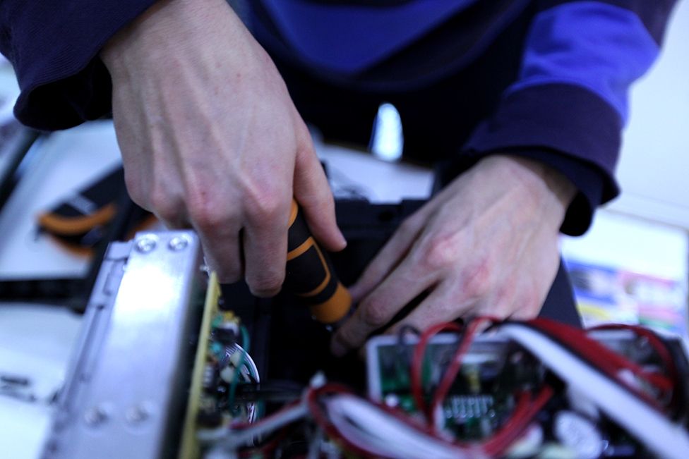 Volunteers repair electrical items at the Fixing Factory in Camden, London