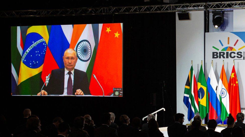Russia's president Vladimir Putin speaks via video link during a press conference on the closing day of The Brics summit at the Sandton Convention Center on August 24, 2023