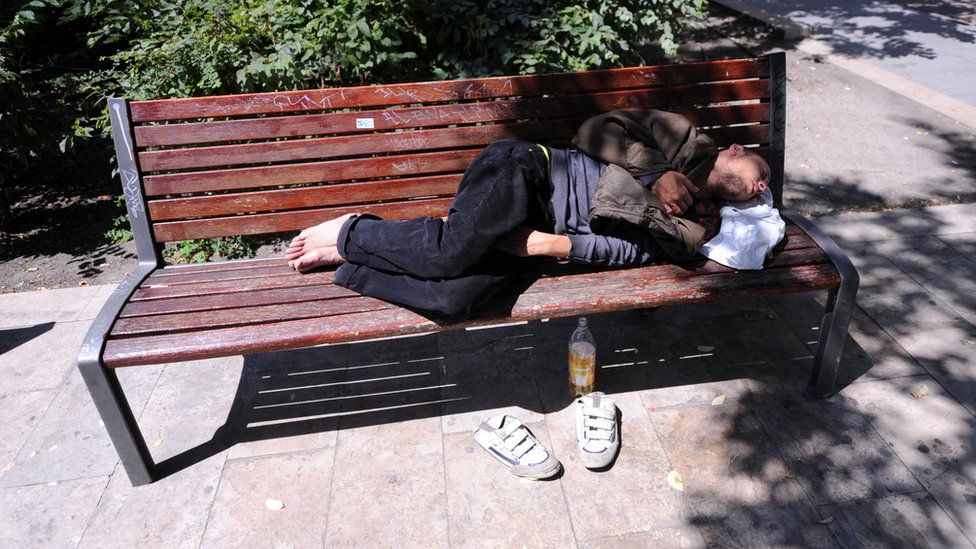 A rough sleeper on a park bench in Budapest