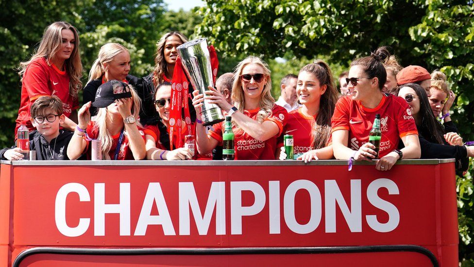Liverpool Women celebrate with the FA Women's Championship trophy on an open-top bus during the trophy parade in Liverpool