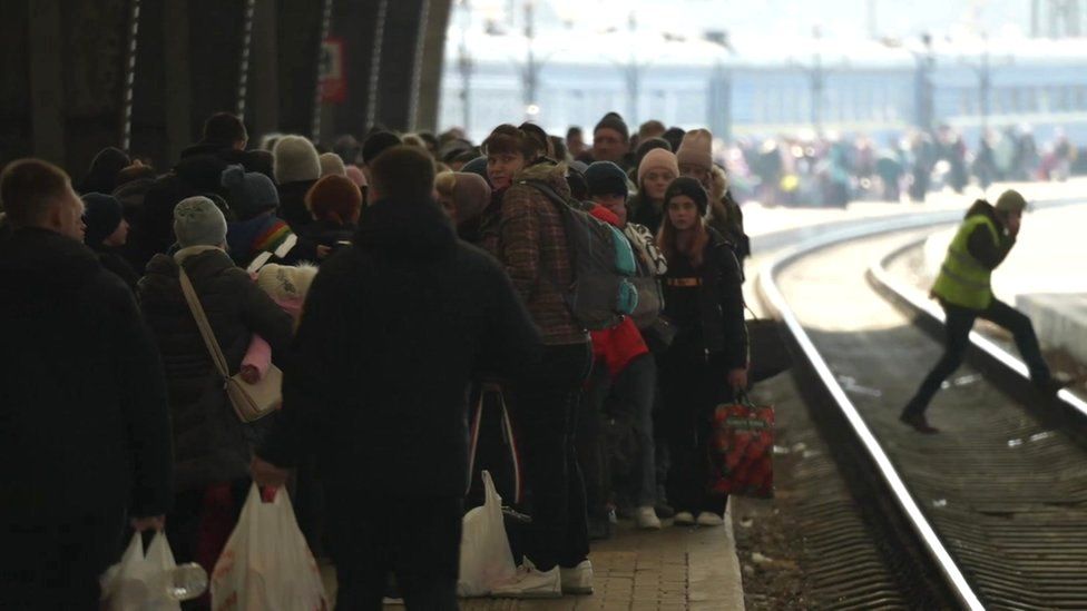 People wait to travel to safety by train in Ukraine following the invasion by Russian forces