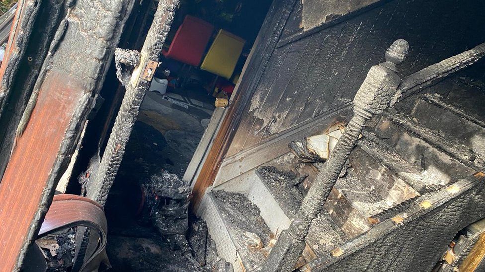 Fire-damaged hallway in a house