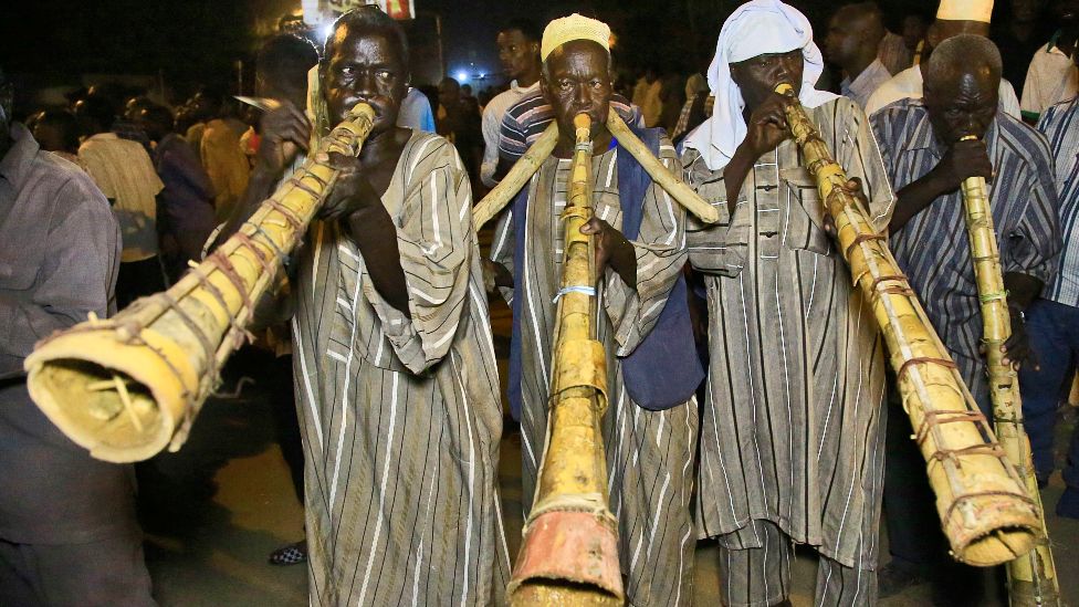 Sudanese protesters blowing traditional horns take to the streets in the capital Khartoum during a demonstration demanding the dissolution of the transitional government - 18 October 2021