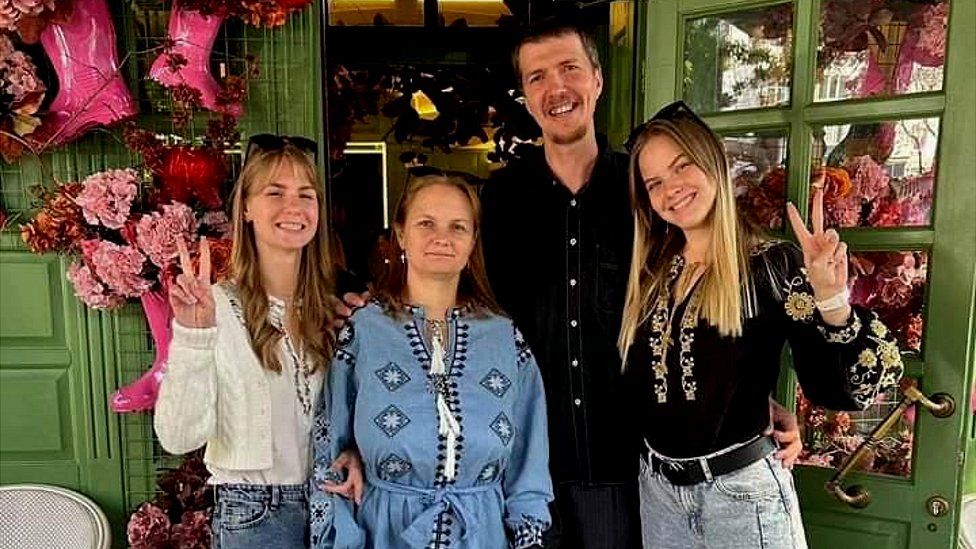 Daria, her husband and two daughters at a birthday party