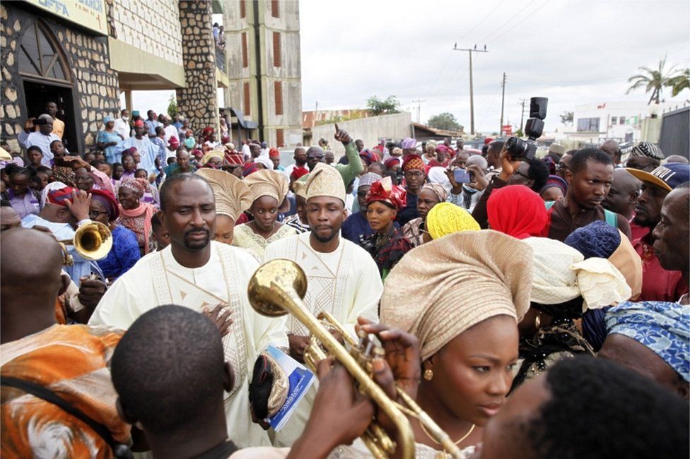 People crowd outside a church during a funeral in Offa, Kwara state, on 19 August.