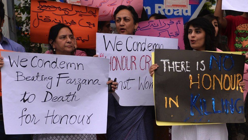 Pakistani human rights activists hold placards as they chant slogans during a protest in Islamabad on May 29, 2014 a