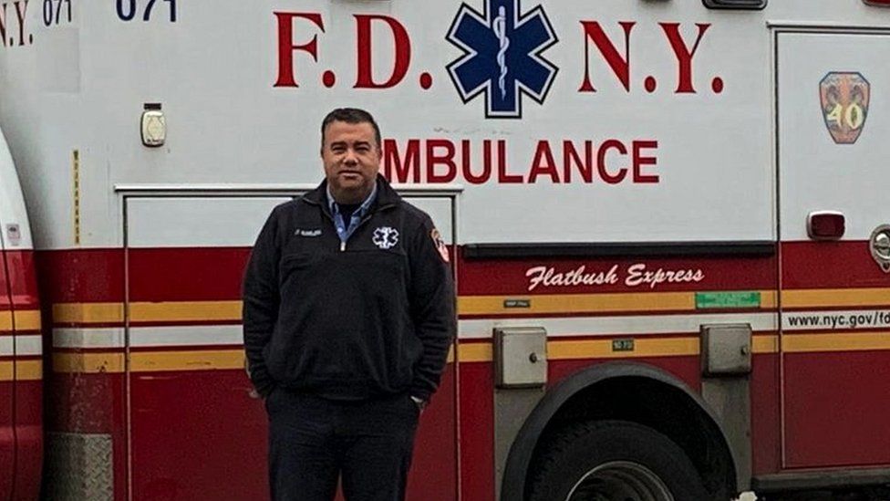 Anthony Almojera in front of his ambulance