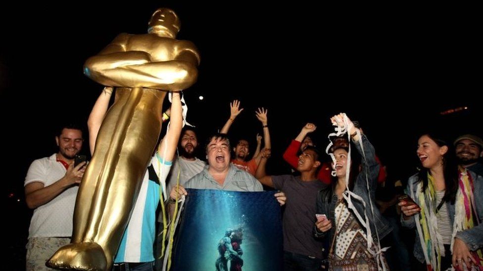Fans of Mexican director Guillermo del Toro celebrate at La Minerva square, in Guadalajara, Jalisco State, on March 4, 2018, after del Toro won the Oscar for "The Shape of Water."