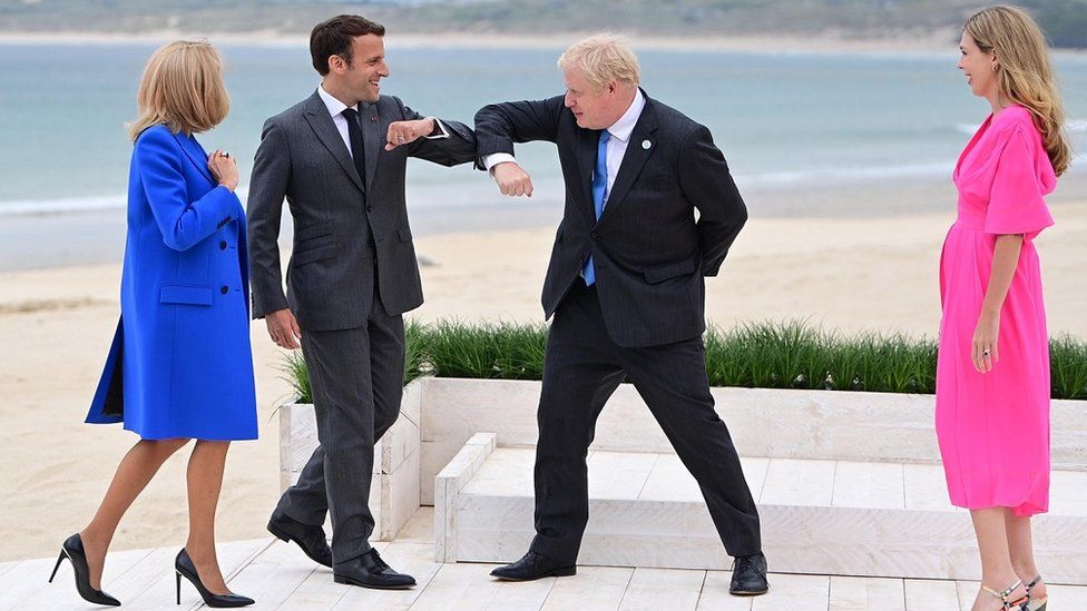 France's President Emmanuel Macron (centre L) greets Prime Minister Boris Johnson (centre R) at the official leaders welcome during the G7 summit