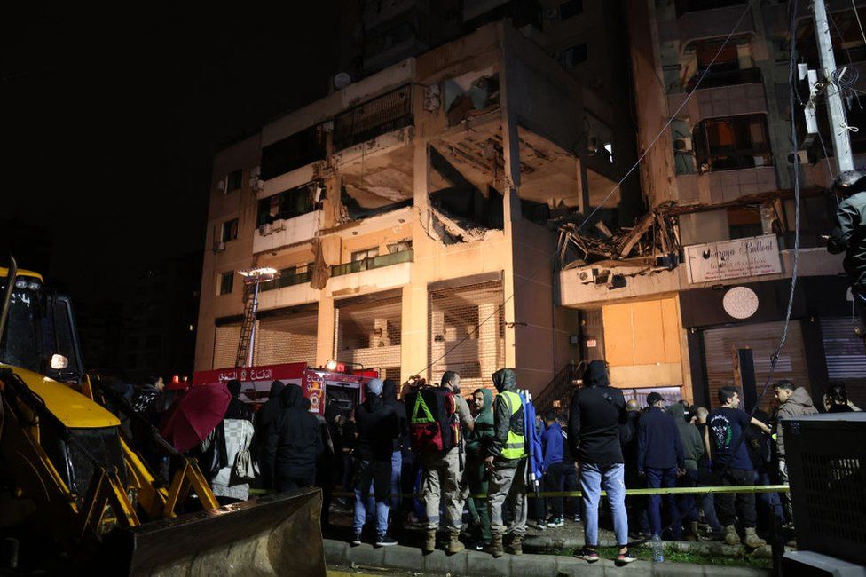 Lebanese emergency responders gather at the site of a strike, reported by Lebanese media to be an Israeli strike targeting a Hamas office, in the southern suburb of Beirut on January 2, 2024.