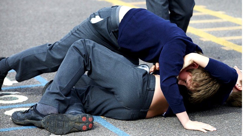 Two schoolboys fighting