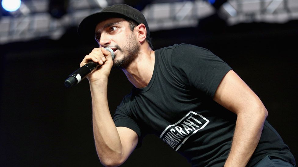 Riz Ahmed on stage in 2017
