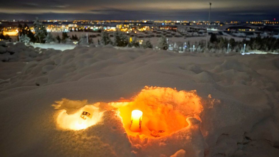 Candles are laid in snow at Ask on 2 January 2021