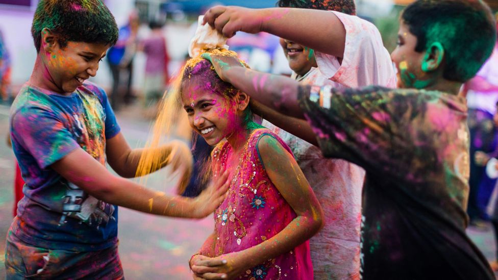 Children throwing coloured powder on each other during the Hindu Holi festival in Durban, South Africa - Monday 9 March 2020