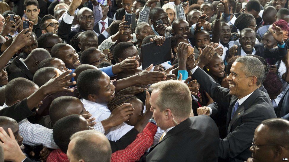 US President Barack Obama (R) greets the crowd after speaking at a stadium in Nairobi on July 26, 2015