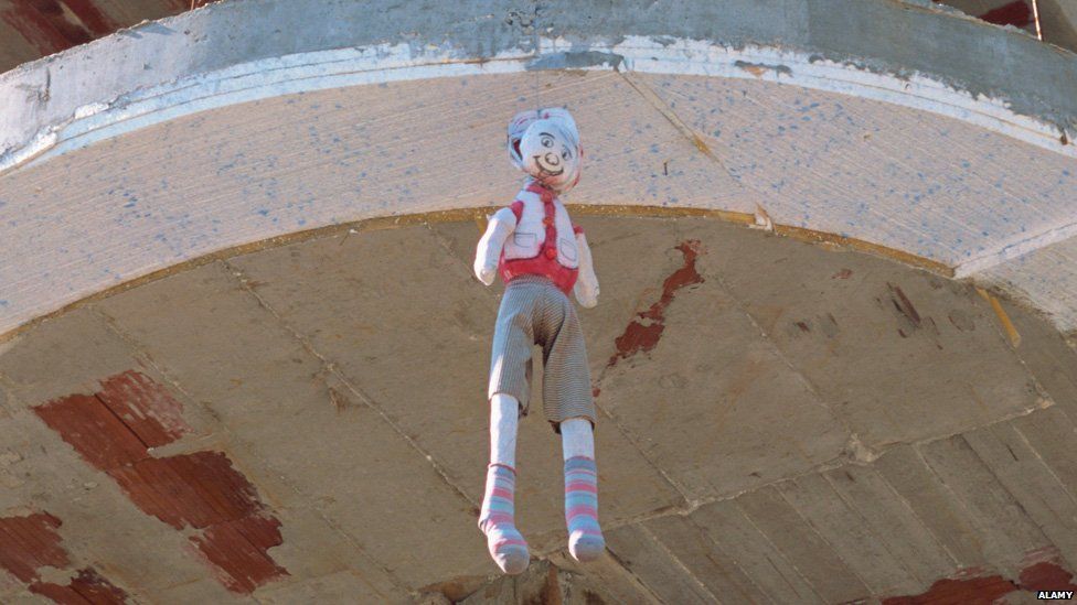 Dummy hanging from building in Albania