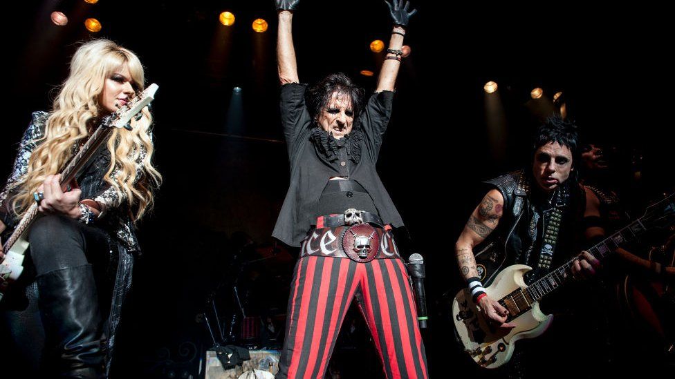 Orianthi, Alice Cooper and Tommy Henricksen perform on stage at the Civic Hall on October 25, 2012 in Wolverhampton