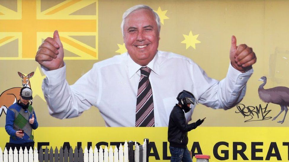 A billboard ad for Clive Palmer shows him flashing a thumbs up in front of an Australian flag with text reading: "Make Australia Great"