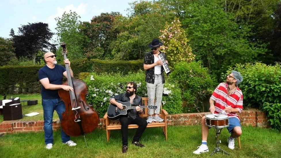 Todd Sharpville and his band jam in a garden as they isolate together with their families and pets